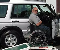 Wheelchair vehicle ramp, going off-roading in his Landy