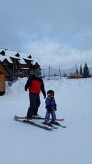 Dad and 3 year old daughter ready to ski