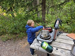 Kid cooking while camping